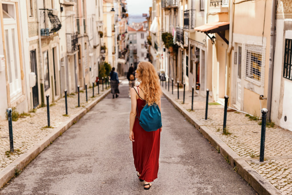 Woman walking alone in an old European city.